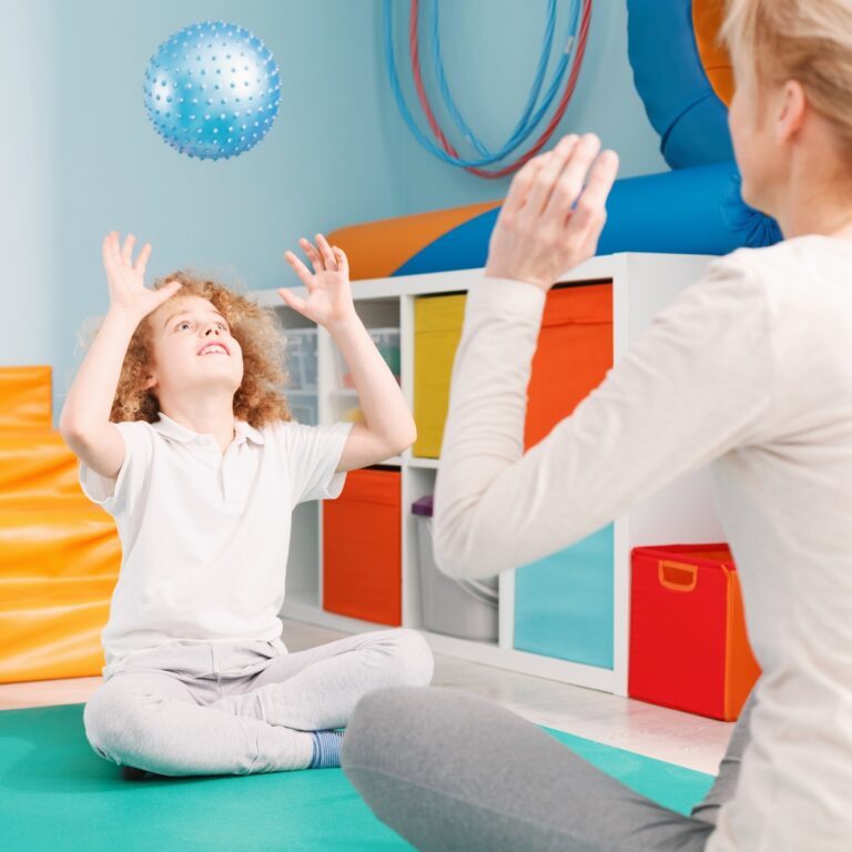 Therapist and boy playing ball